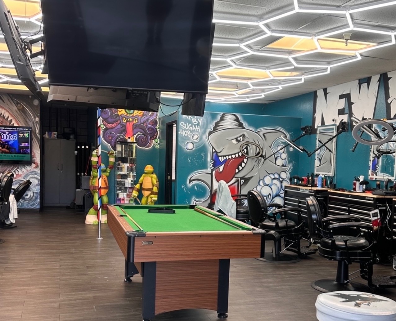 New Wave of SJ Barbershop interior with barber chairs, murals, and pool table
